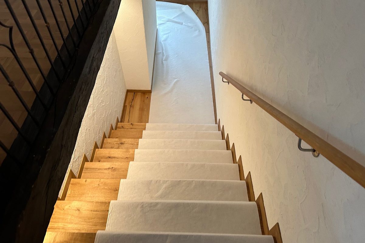 Mit Schutzvlies abgedeckte Treppe in einem Wohnhaus